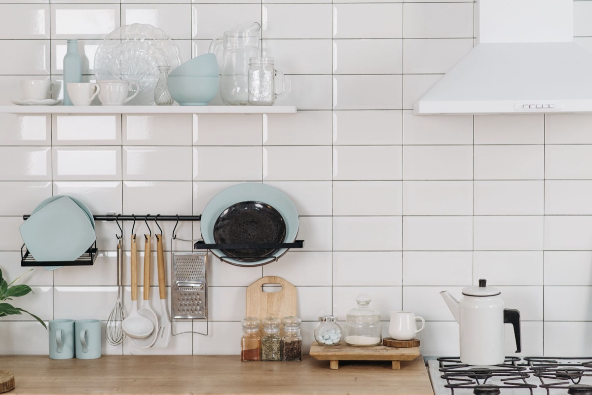 A selection of stainless steel pots and pans neatly stacked in a modern kitchen setting